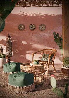 an outdoor area with wicker furniture and cactus plants