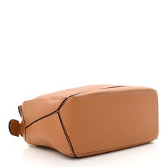 This is an authentic LOEWE Soft Grained Calfskin Small Puzzle Bag in Light Caramel. This stunning shoulder bag is crafted of grained calfskin leather in brown. The bag features a rolled leather handle, a rear zipper pocket, and an optional, adjustable leather shoulder strap with polished gold hardware. The top zipper opens to a natural fabric interior with a patch pocket. Small Puzzle Bag, Puzzle Bag, Natural Fabric, Bag Light, Natural Fabrics, Leather Handle, Gold Hardware, Patch Pocket, Zipper Pocket