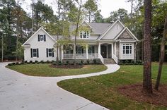 a white house surrounded by trees and grass