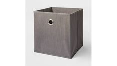 a gray storage bin with a hole in the middle and a handle on one side