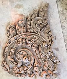 an intricately carved piece of wood on the ground