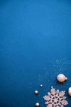 christmas decorations on a blue background with snow flakes