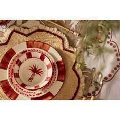 a place setting with palm tree plates and utensils