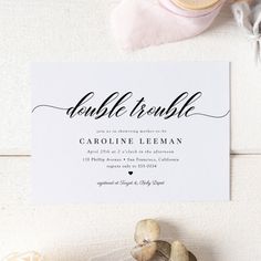 a wedding card with the word double trouble on it next to some seashells