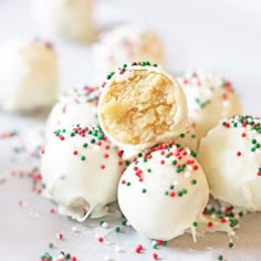 some white cake balls with sprinkles on them