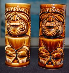 two brown vases sitting on top of a table