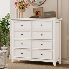 there is a white dresser with many drawers in the room and a clock on the wall