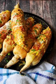 chicken legs covered in seasoning on a black plate