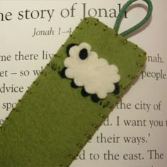 a green bookmark with a sheep on it