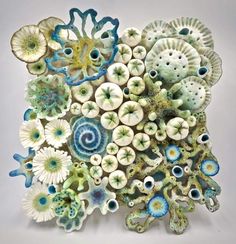 an art piece made out of ceramic flowers and shells