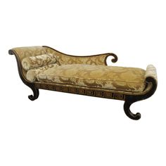 an ornately decorated chaise lounge chair with gold and brown upholstered fabric