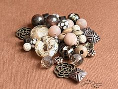 a pile of beads sitting on top of a brown surface