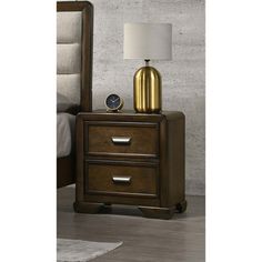 a night stand with two drawers and a lamp