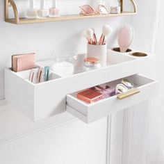 there is a white counter with makeup and other items on it in the bathroom sink