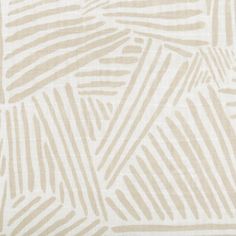 a beige and white striped fabric with small, wavy lines on the back of it