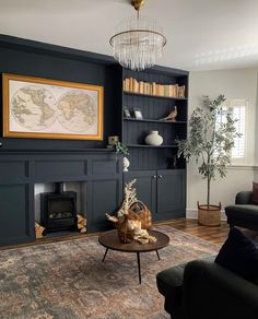 a living room filled with furniture and a fire place under a painting on the wall