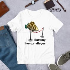 Here at SassyLabelShop we specialize in offensive shirts, ironic shirts, sarcastic shirts, weird shirts, stupid shirts, meme shirts, retro shirts, inappropriate shirts, trending shirts and funny shirts. Inspired by the absurdity of the human condition but also by memes, pop-culture, funny sayings, funny quotes and anything else hilarious. Our shirts are the perfect addition to your humorous tshirt collection or to give as a funny gift. We use a high quality unisex tshirt and guarantee the DTG screen print will be 100% perfect. ABOUT THE SHIRT: Unisex Staple T-Shirt | Bella + Canvas 3001 The Unisex Staple T-Shirt feels soft and light with just the right amount of stretch. It's comfortable and flattering for all. We can't compliment this shirt enough-it's one of our crowd favorites, and it's Fishing T Shirts Funny, Extremely Specific And Overly Vague Shirts, Silly Shirt Ideas, Funny Grafic Tees, Funny Tshirts Memes, Weird Shirts Aesthetic, Weirdly Specific Shirts, Liver Privileges, T-shirt Prints