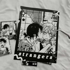 an image of two anime characters kissing on the cover of a book with stickers around it