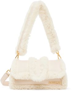 Padded shearling shoulder bag in beige. Logo hardware at face. · Detachable carry handle · Detachable shoulder strap · Patch pocket at back face · Foldover flap · Patch pocket at interior · Cotton twill lining · Logo-engraved gold-tone hardware · H4.5 x W8 x D4 in Part of the Le Chouchou collection. Supplier color: Light beige Jacquemus Bag, Leather Messenger Bag, Leather Messenger, Light Beige, Gold Tone Metal, Flip Flop, Valentino Garavani, Miu Miu, Bottega Veneta