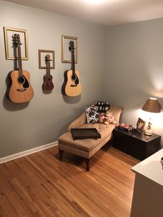 a living room with guitars hanging on the wall