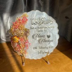 a glass plate with flowers on it sitting on a table