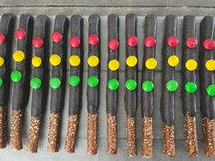 many sticks are decorated with different colors and sizes, along with sprinkles on them