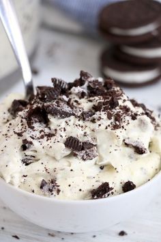 a white bowl filled with ice cream and oreo cookies