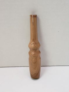 a wooden vase sitting on top of a white table