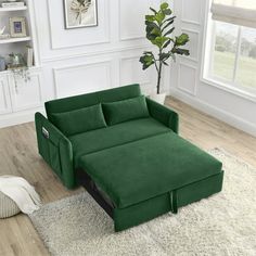 a green couch sitting on top of a white rug