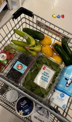 a shopping cart filled with assorted fruits and vegetables