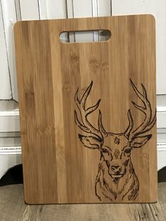 a wooden cutting board with an image of a deer on it