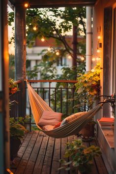 Cozy hammock on a small balcony adorned with string lights and greenery, illustrating small apartment balcony design ideas. Apartment Balcony Design Ideas, Loft Conversion Balcony, Small Apartment Balcony, Modern Exterior House Designs