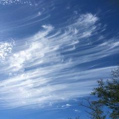 the sky is filled with clouds and trees