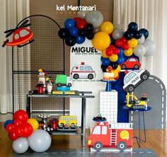 a room filled with balloons and toys on top of a hard wood floor