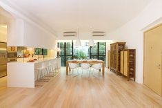 an open kitchen and dining room with wood flooring