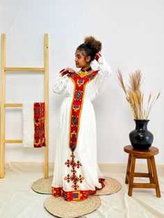 Embrace timeless elegance with this gorgeous red Habesha dress, intricately designed with stunning patterns that add a touch of sophistication. The bold red hue exudes confidence and grace, making it perfect for special occasions, cultural celebrations, or holiday gatherings. Crafted from high-quality fabric, this dress balances traditional Ethiopian charm with a modern silhouette, offering both style and comfort. Ideal for those who want to make a striking impression while celebrating their heritage. Key Features: Cultural Heritage: Adorned with exquisite handwoven details that honor Ethiopia's rich traditions. Flattering Design: The flowing silhouette ensures you look stunning at weddings, festivals, or any event where you want to shine. Ethical Craftsmanship: Handmade by skilled Ethiopi Habesha Dress, Ethiopian Dress, Habesha Kemis, Cultural Celebration, Dress Clothes For Women, Ethiopia, Special Occasion Dresses, Timeless Elegance, Beautiful Dresses