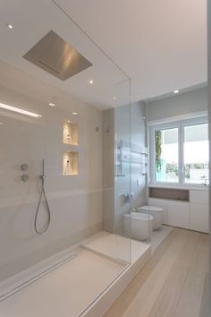 a bathroom with a shower, toilet and sink in it's own area is shown