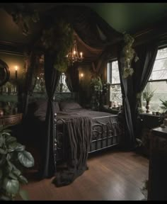 a bed sitting next to a window in a room with wooden floors and curtains on the windowsill