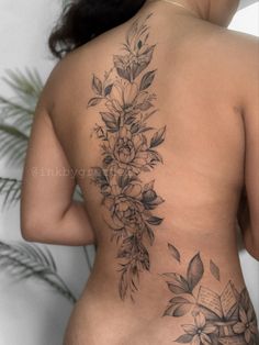 the back of a woman's body with flowers on it