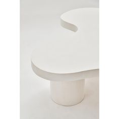 a white table with an oval shaped design on the top, and curved edges at the base