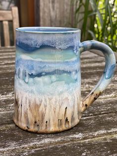 a blue and white mug sitting on top of a wooden table