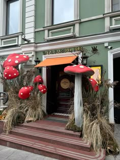 a building with red mushrooms growing out of it's front door and steps leading up to the entrance