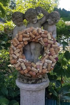 a wreath made out of wine corks in the shape of two cherubs