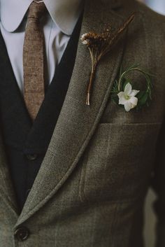 a man in a suit with a boutonniere on his lapel