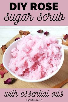 a bowl filled with pink sugar on top of a wooden cutting board