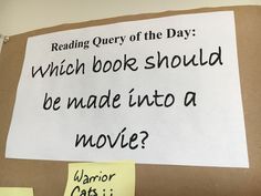 a piece of paper taped to a bulletin board that reads, reading query of the day which book should be made into a movie?