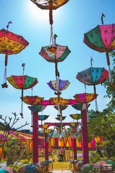 many colorful umbrellas are hanging in the air