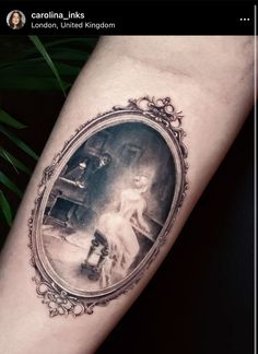 a woman's arm with an old fashion photo in the frame on top of it