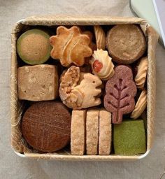 a box filled with different types of cookies and pastries on top of a table