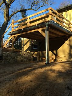 a house with a wooden deck in the shade